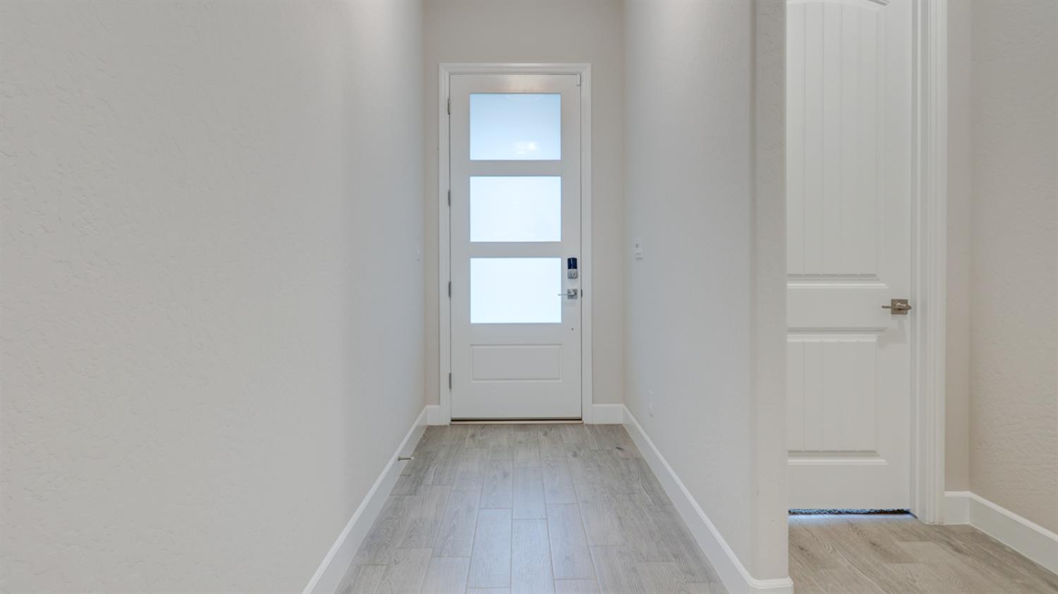 935 Talus Way Madera, CA 93636 - Photo 2 of 34 a view of a hallway with wooden floor
