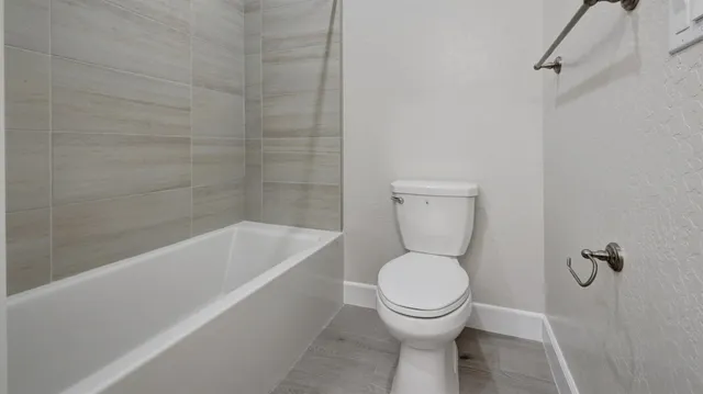 a bathroom with a toilet and bathtub