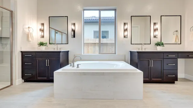 a spacious bathroom with a tub sink and mirror
