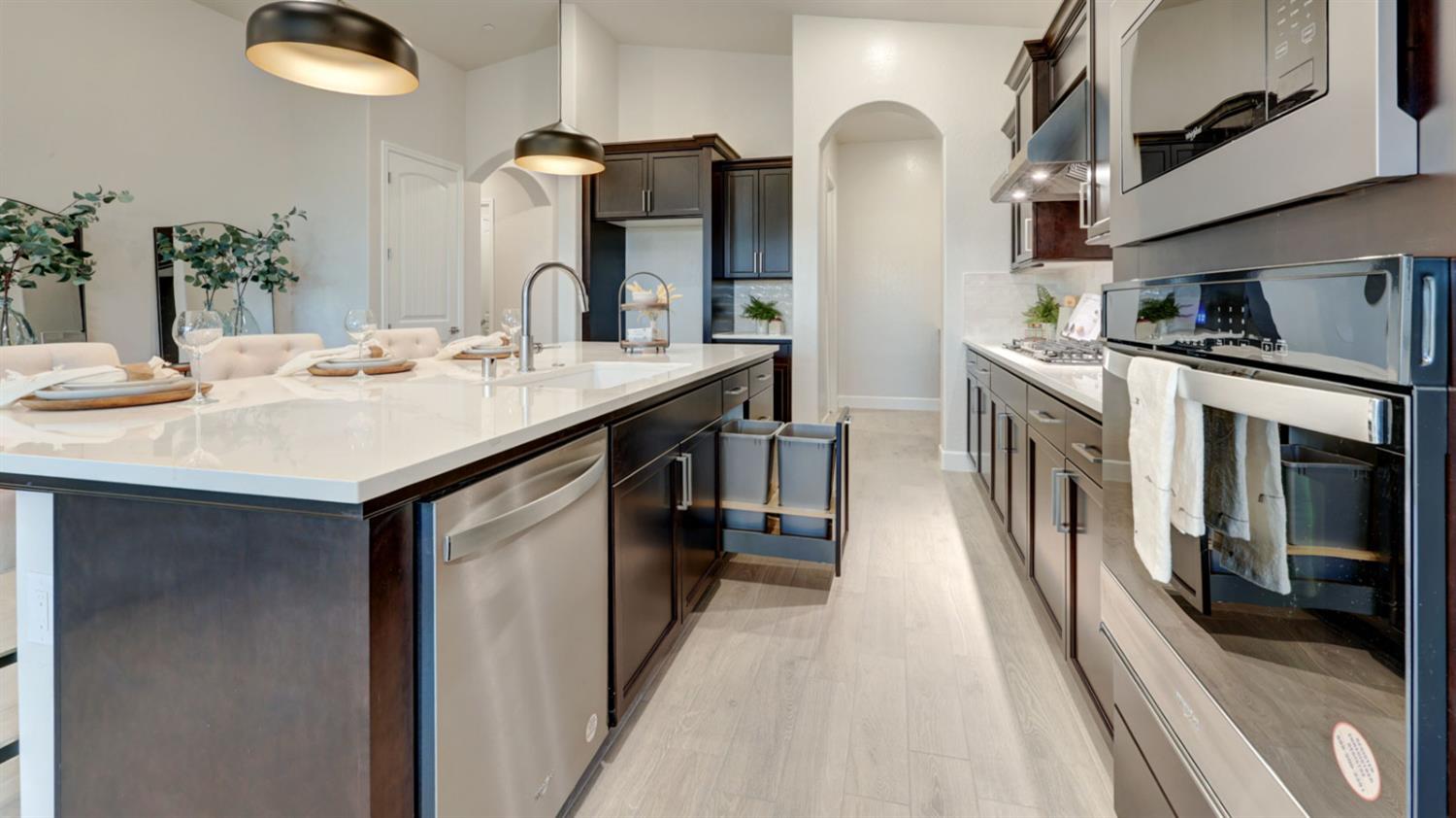 935 Talus Way Madera, CA 93636 - Photo 6 of 34 a kitchen with stainless steel appliances granite countertop a sink and a refrigerator