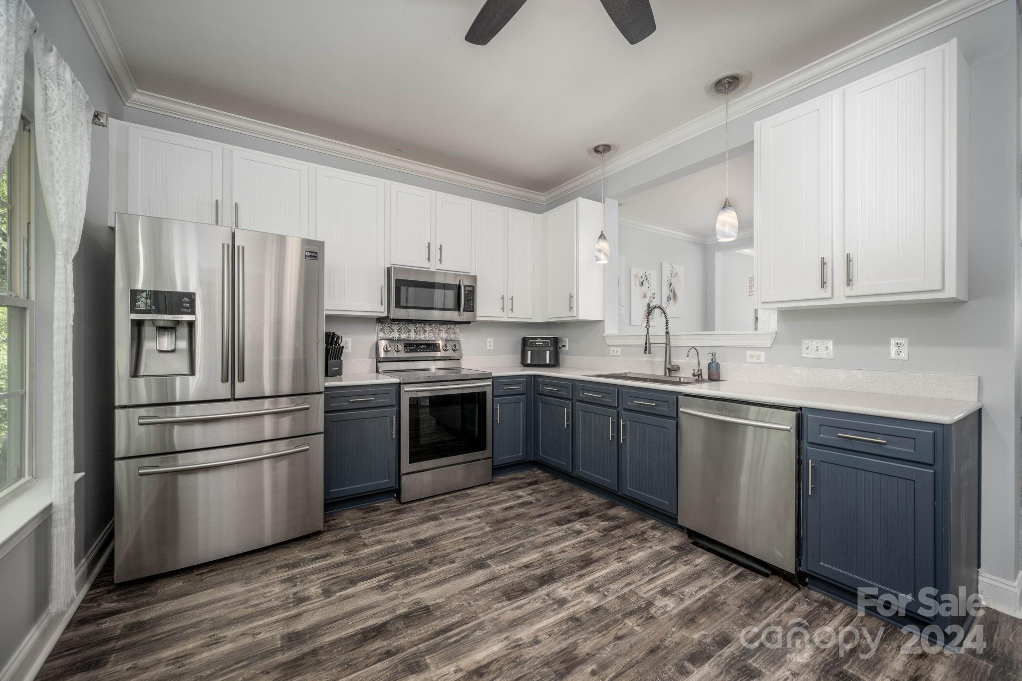 147 High Ridge Road Mooresville, NC 28117 - Photo 11 of 30 a kitchen with stainless steel appliances granite countertop a refrigerator a stove top oven a sink and dishwasher