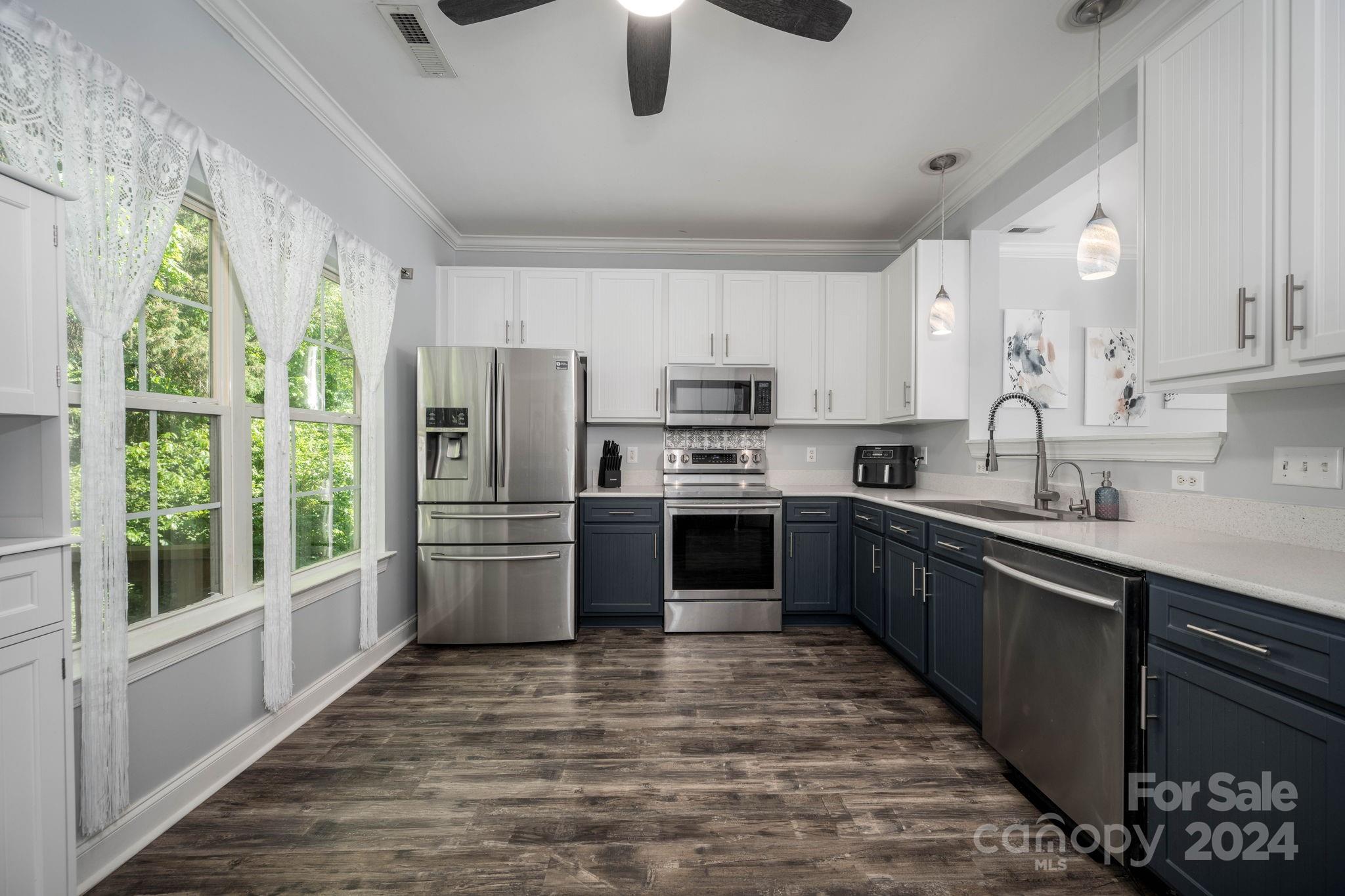 147 High Ridge Road Mooresville, NC 28117 - Photo 13 of 30 a kitchen with stainless steel appliances granite countertop a stove a sink and a refrigerator