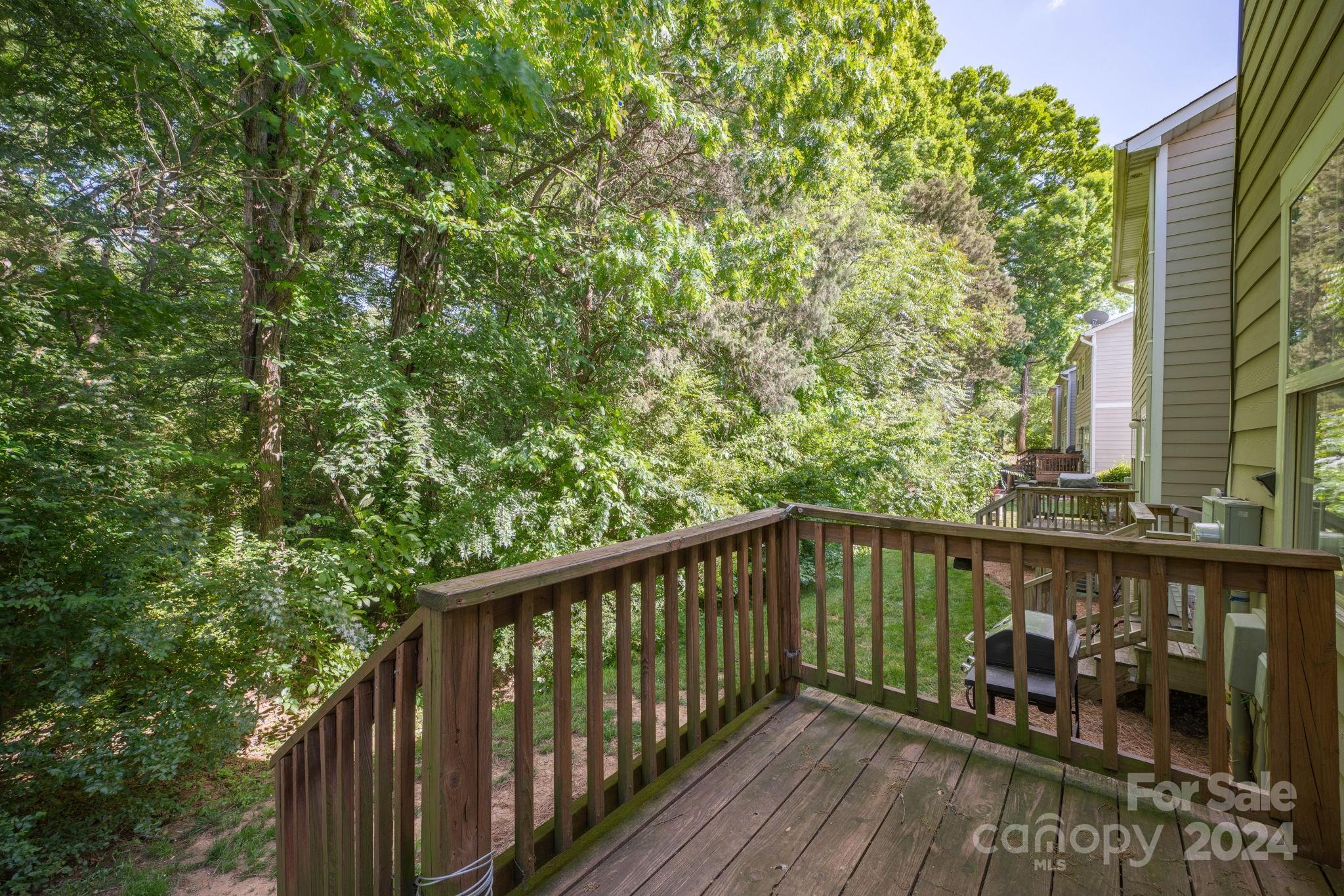 147 High Ridge Road Mooresville, NC 28117 - Photo 26 of 30 a balcony with wooden floor and trees in the back