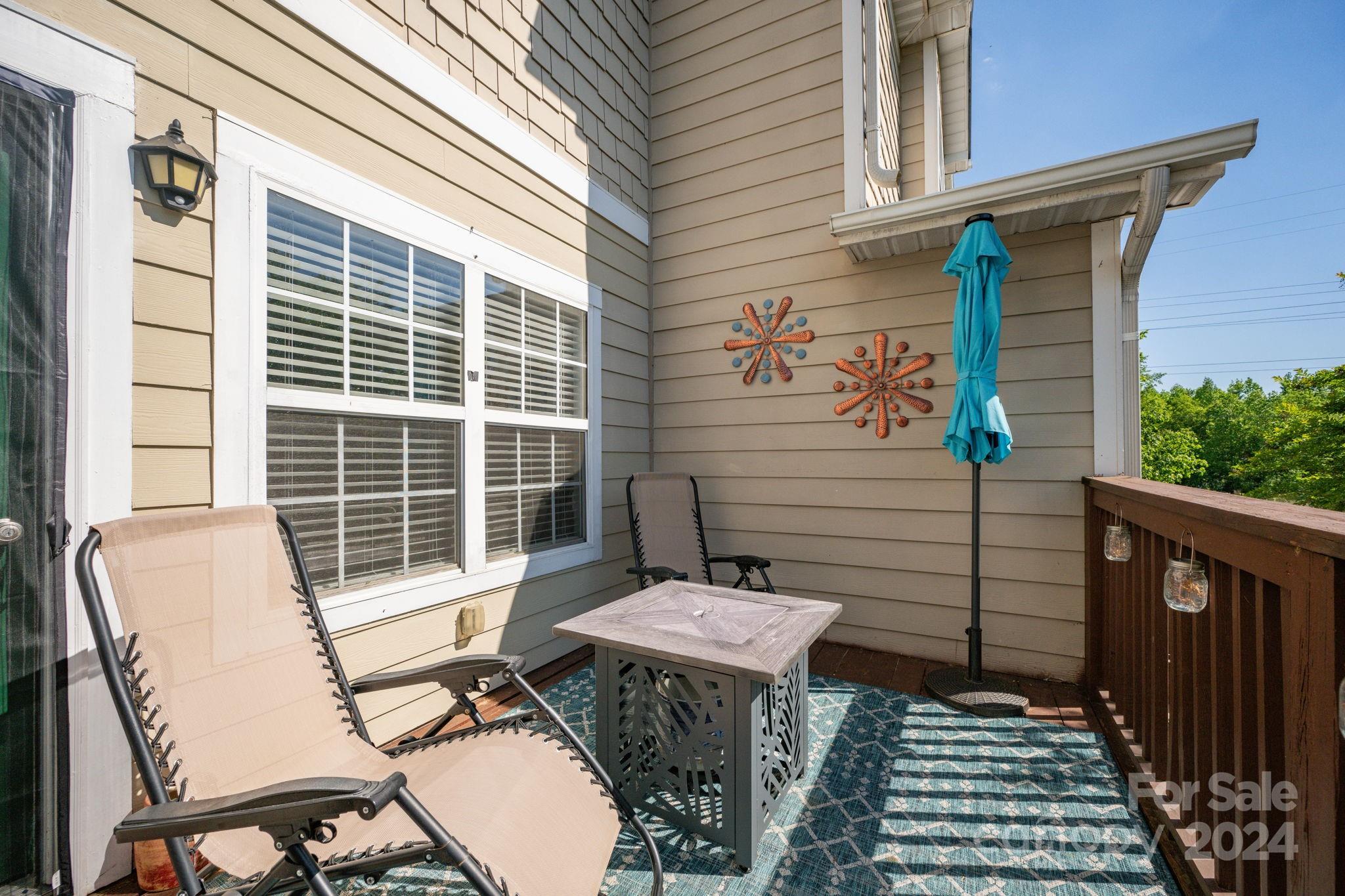147 High Ridge Road Mooresville, NC 28117 - Photo 28 of 30 a view of a patio with table and chairs with wooden floor and fence