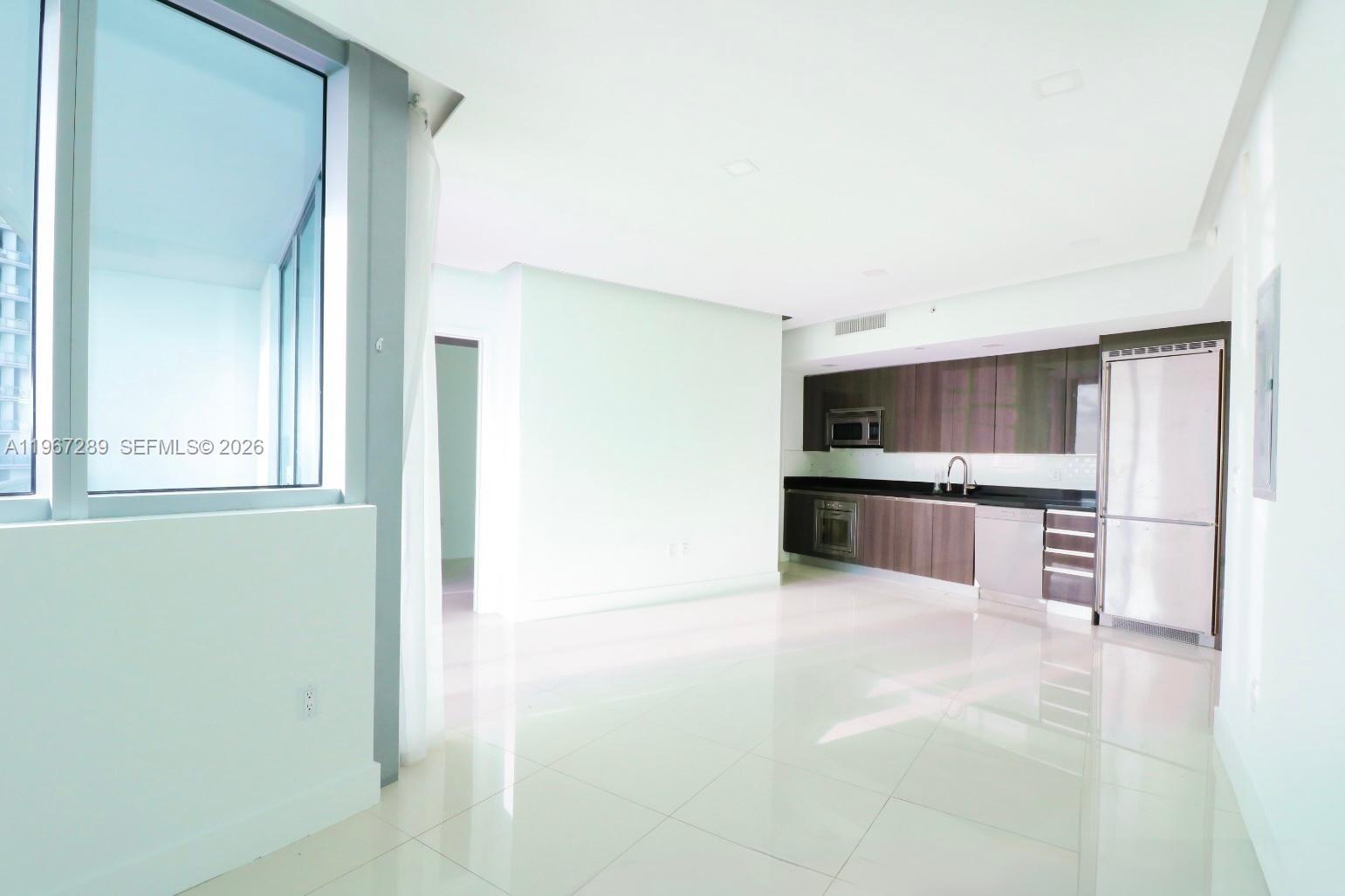 92 Southwest 3rd Street, Unit 2706 Miami, FL 33130 - Photo 11 of 13 a view of kitchen with stainless steel appliances a refrigerator and a stove top oven