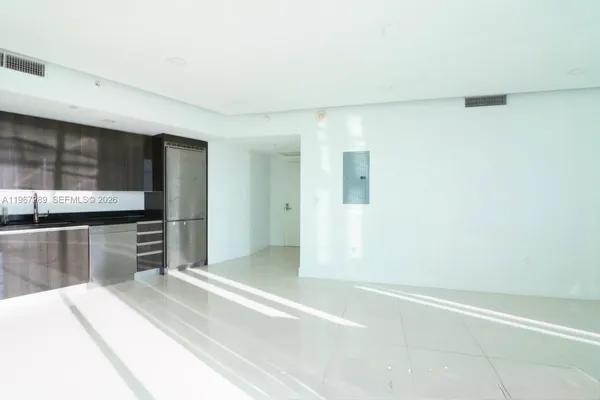 a kitchen with granite countertop a refrigerator and a stove