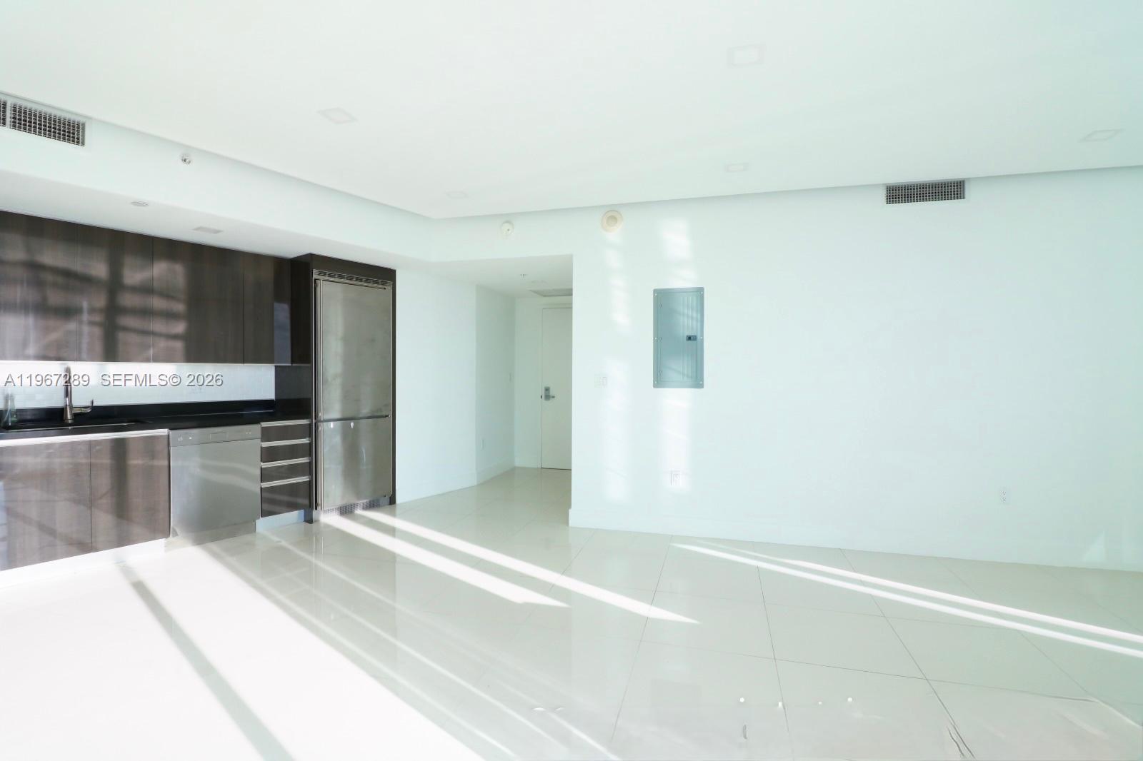 92 Southwest 3rd Street, Unit 2706 Miami, FL 33130 - Photo 13 of 13 a kitchen with granite countertop a refrigerator and a stove