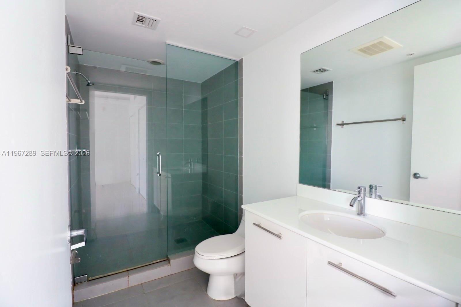 92 Southwest 3rd Street, Unit 2706 Miami, FL 33130 - Photo 5 of 13 a bathroom with a sink toilet and shower