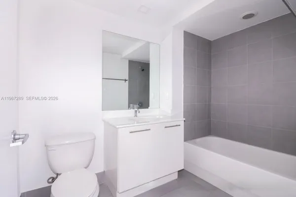a bathroom with a toilet a sink and bathtub