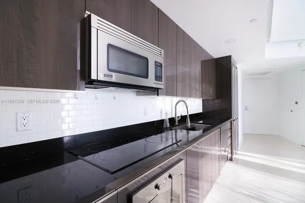 a kitchen with a sink and microwave