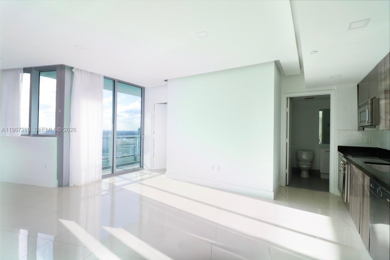 92 Southwest 3rd Street, Unit 2706 Miami, FL 33130 - Photo 10 of 13 a spacious bathroom with a bathtub and a sink