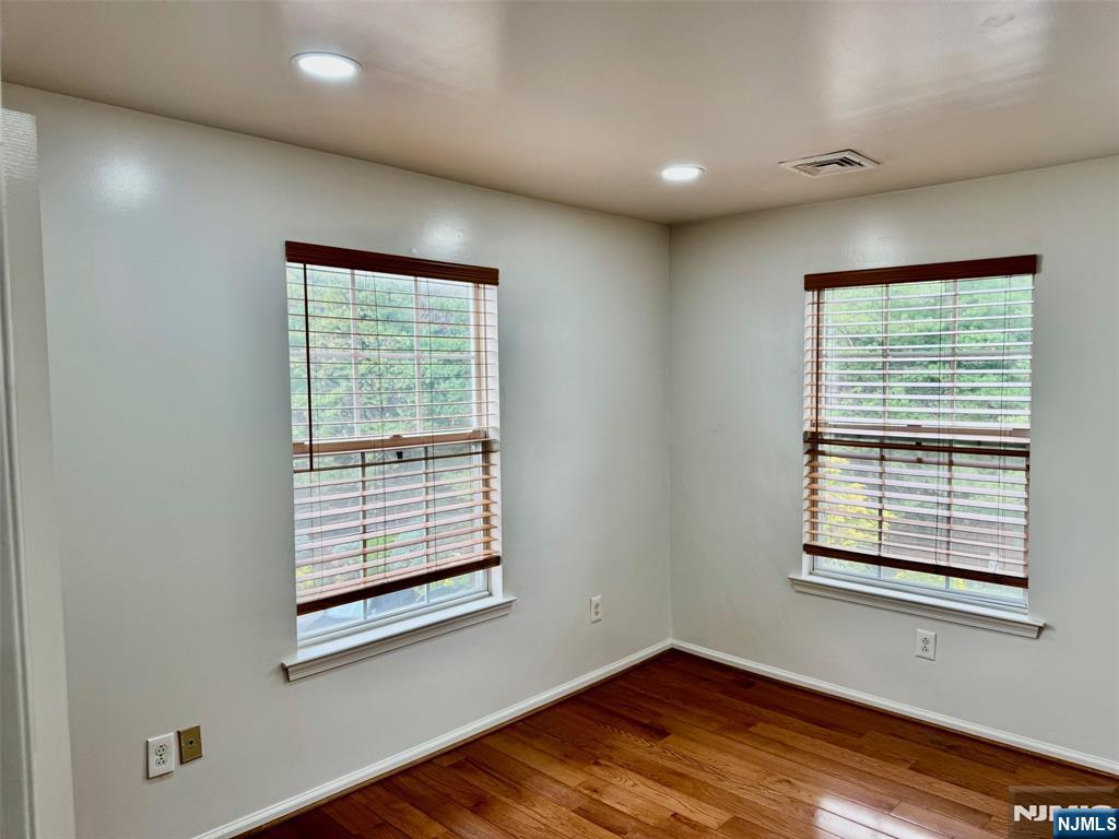 34 Bergen Ridge Road, Unit 2 North Bergen, NJ 07047 - Photo 26 of 41 a view of an empty room with wooden floor and a window