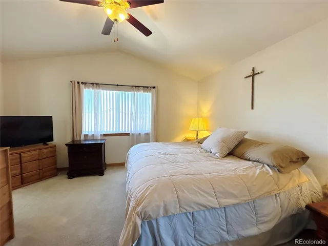 a bedroom with a bed and a television