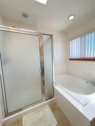 a bathroom with a bathtub and a shower