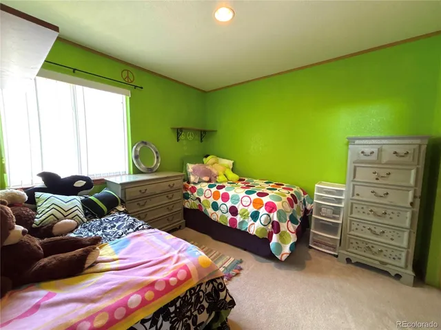 a bedroom with two beds and a window