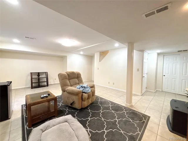 a living room with furniture and a rug