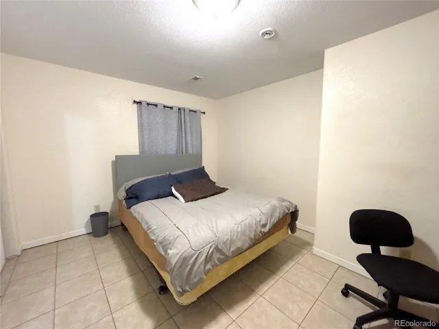 a bedroom with a bed and chair
