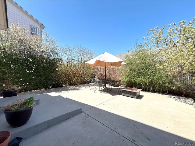 a view of a backyard with sitting area