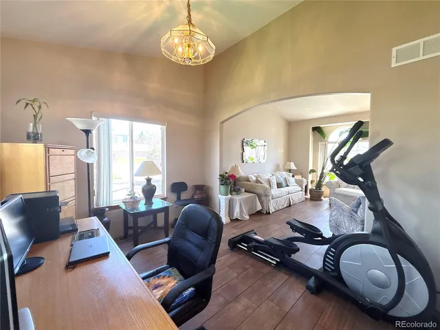a room with furniture or chandelier and a wooden floor