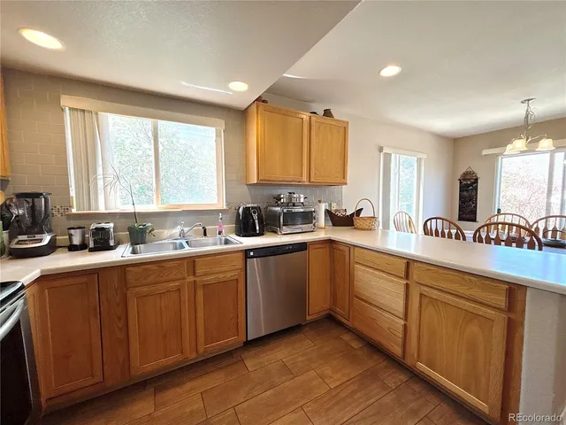 a kitchen with a sink window and cabinets
