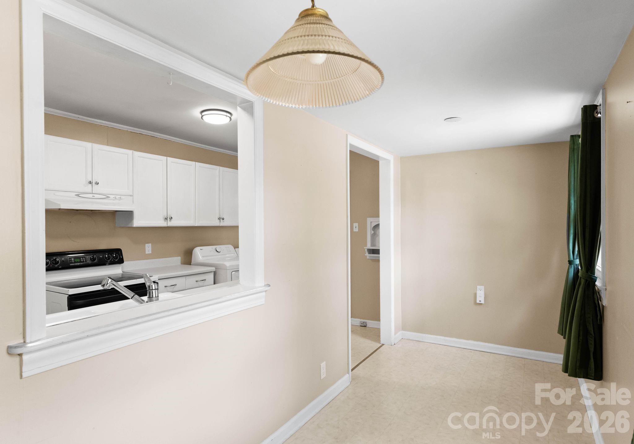 1136 East Woodlawn Road Charlotte, NC 28209 - Photo 15 of 47 a kitchen with stainless steel appliances a refrigerator a stove a microwave and cabinets