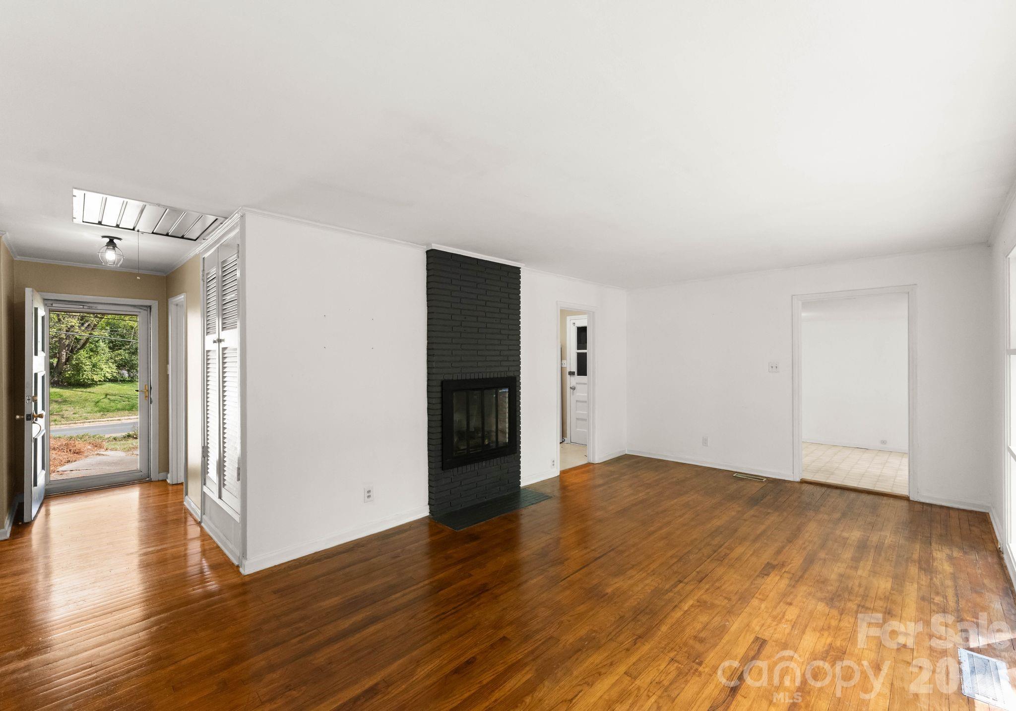 1136 East Woodlawn Road Charlotte, NC 28209 - Photo 17 of 47 a view of an empty room with wooden floor and a window