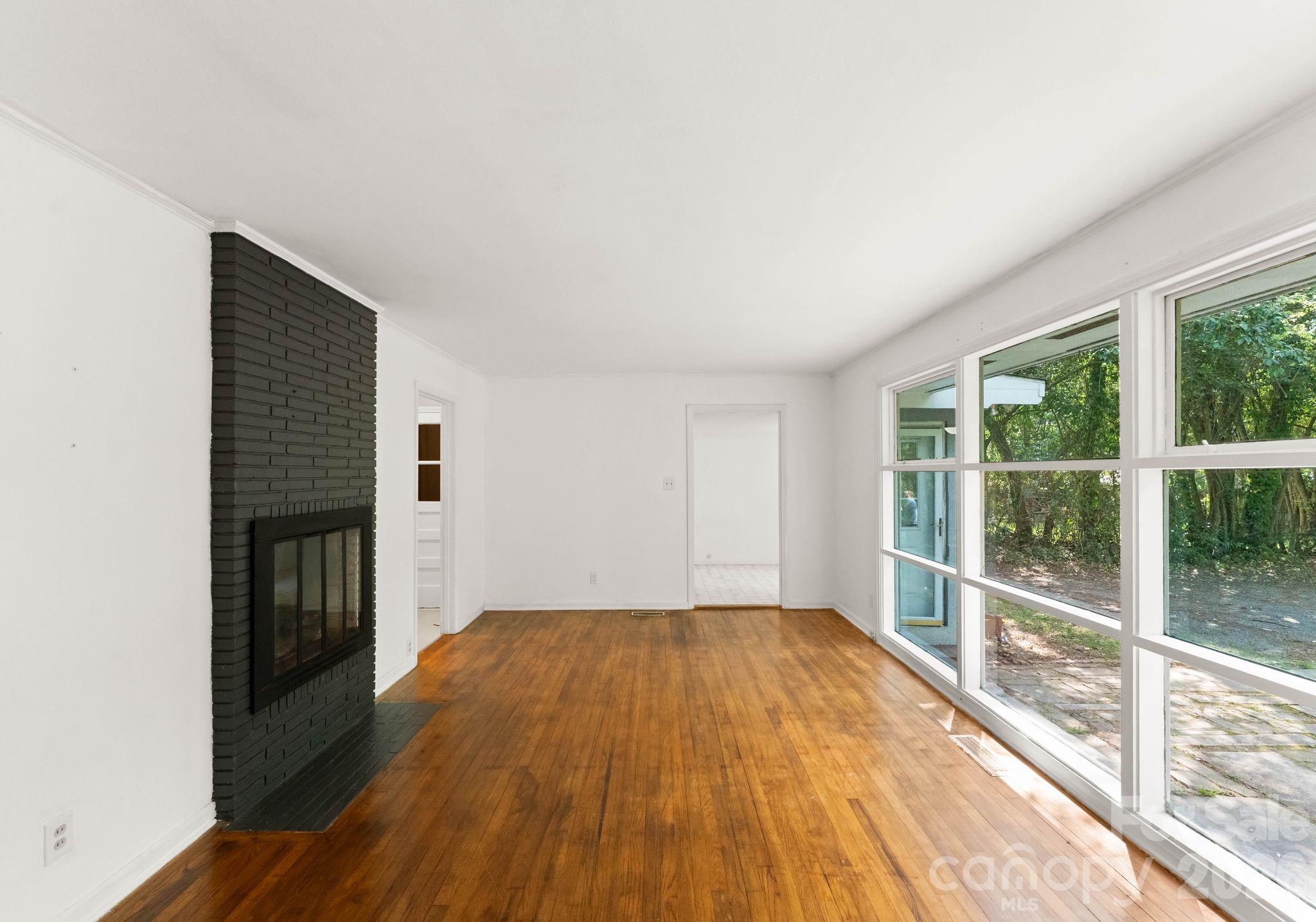 1136 East Woodlawn Road Charlotte, NC 28209 - Photo 19 of 47 a view of a livingroom with wooden floor