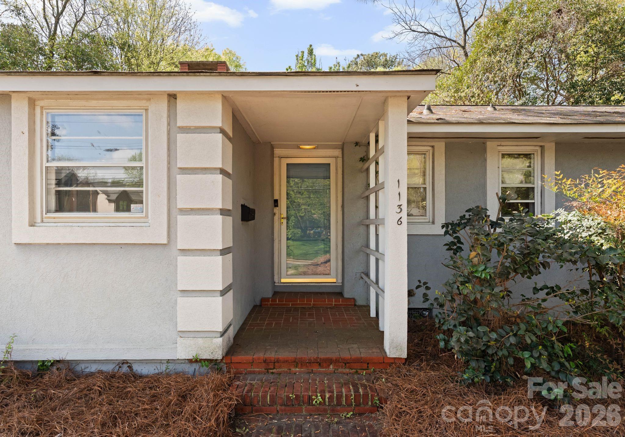 1136 East Woodlawn Road Charlotte, NC 28209 - Photo 2 of 47 a view of a house with backyard and garden