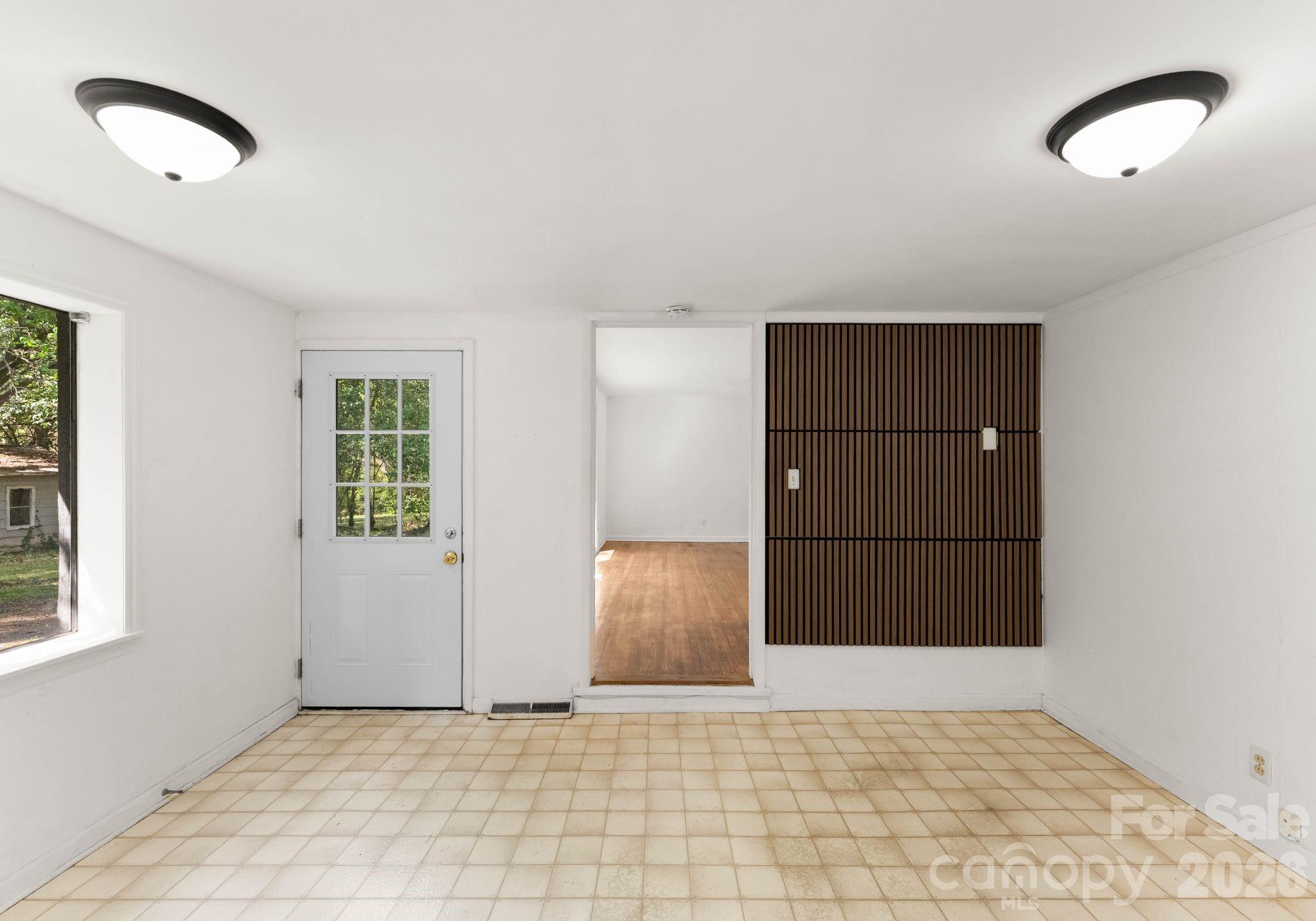 1136 East Woodlawn Road Charlotte, NC 28209 - Photo 25 of 47 a view of an empty room with cabinet and window