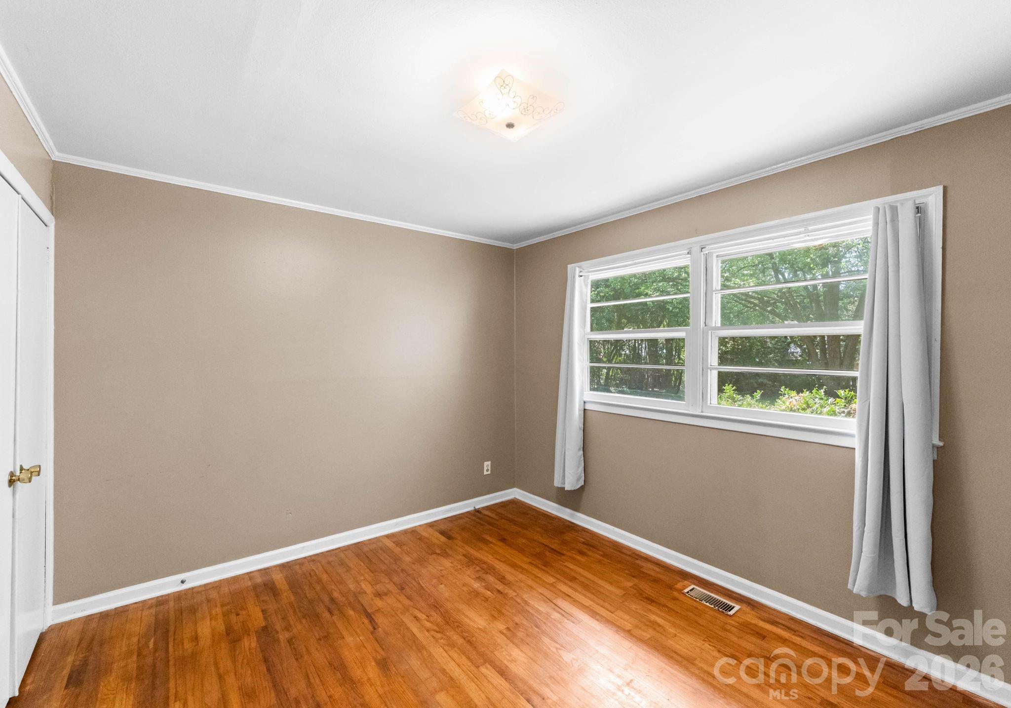 1136 East Woodlawn Road Charlotte, NC 28209 - Photo 27 of 47 a view of a room with wooden floor and a window