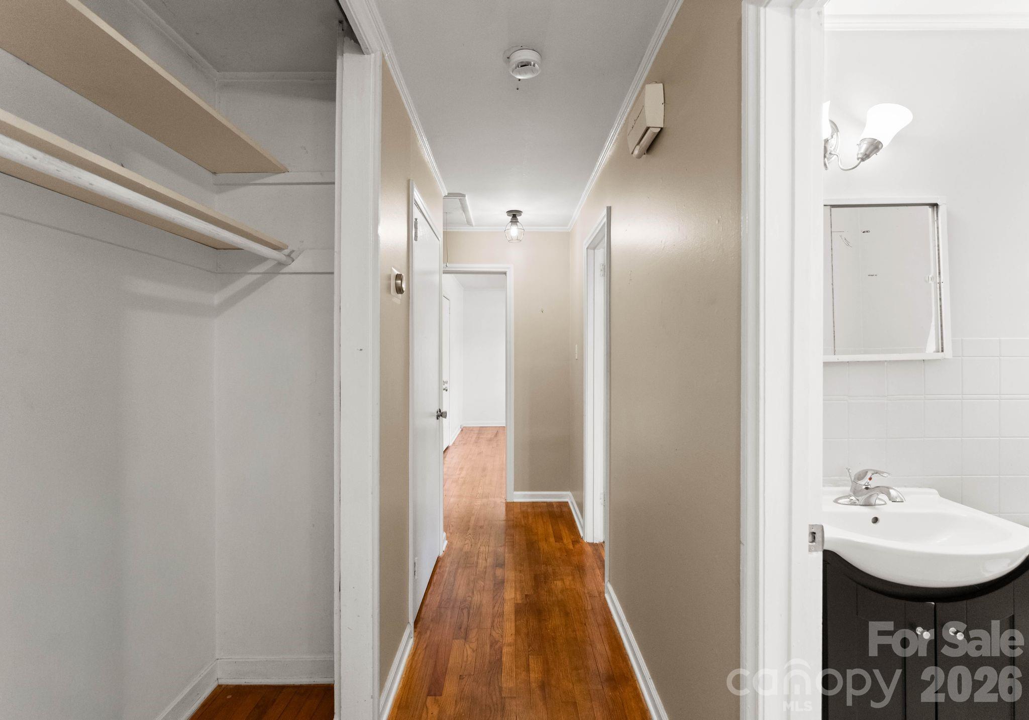 1136 East Woodlawn Road Charlotte, NC 28209 - Photo 35 of 47 a view of a bathroom with a sink and mirror