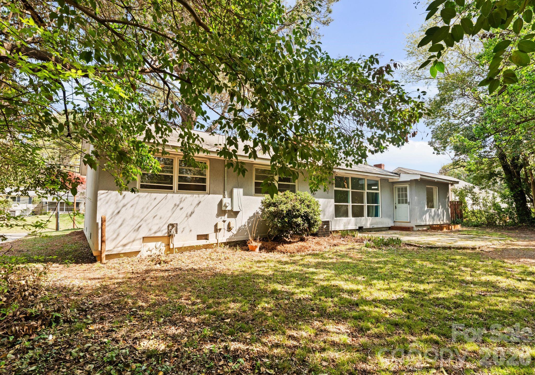 1136 East Woodlawn Road Charlotte, NC 28209 - Photo 41 of 47 a view of a house with a yard