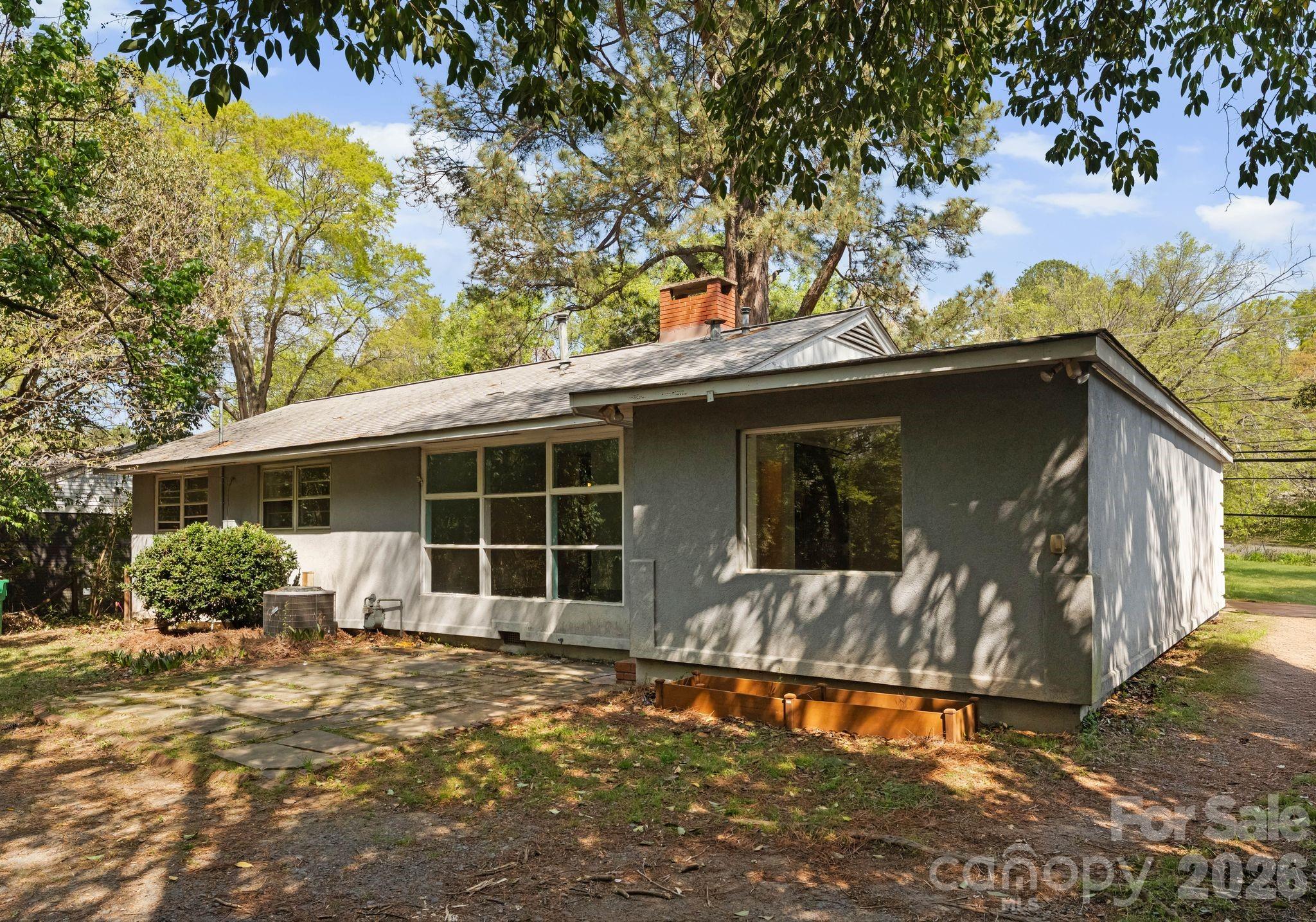 1136 East Woodlawn Road Charlotte, NC 28209 - Photo 43 of 47 a front view of a house with garden
