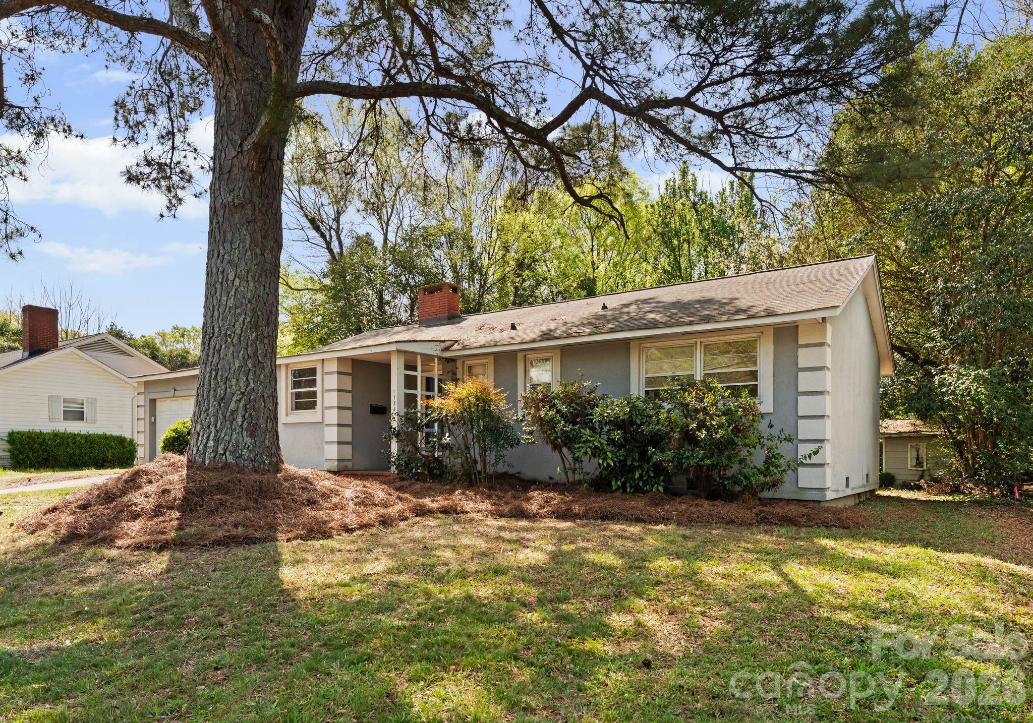 1136 East Woodlawn Road Charlotte, NC 28209 - Photo 46 of 47 a view of a house with garden and yard