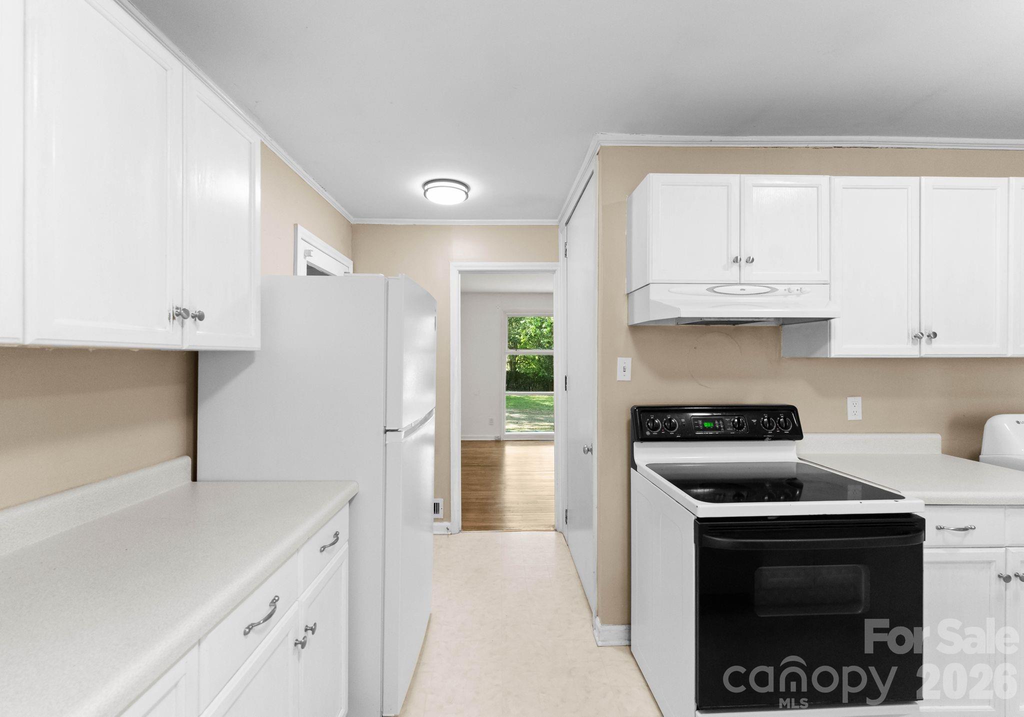 1136 East Woodlawn Road Charlotte, NC 28209 - Photo 5 of 47 a kitchen with cabinets appliances and a window