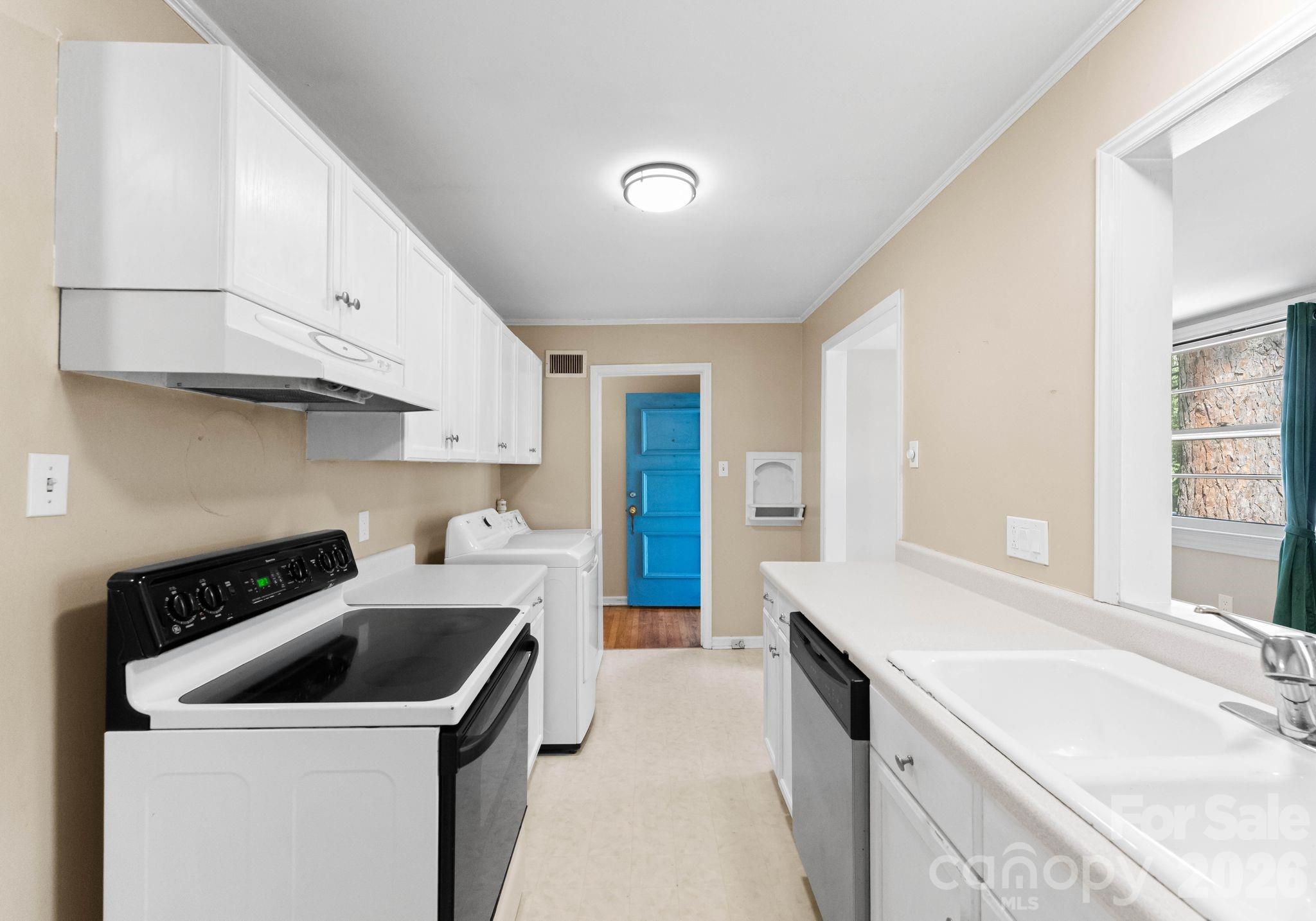 1136 East Woodlawn Road Charlotte, NC 28209 - Photo 7 of 47 a kitchen with a sink a stove and cabinets