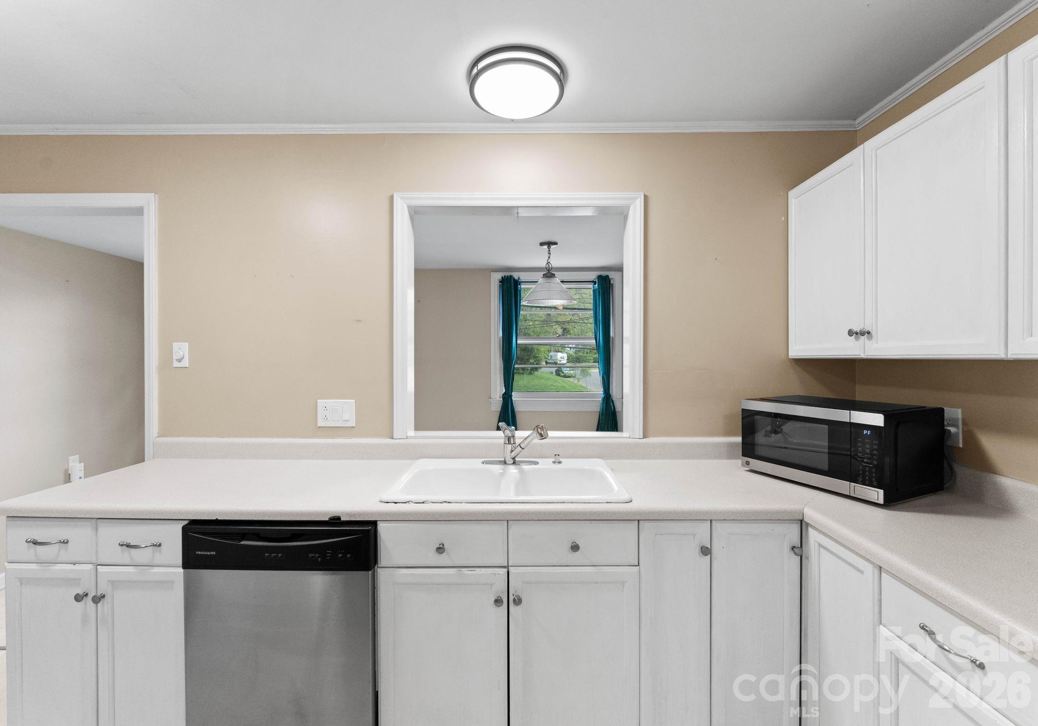 1136 East Woodlawn Road Charlotte, NC 28209 - Photo 8 of 47 a kitchen with granite countertop a sink cabinets and stainless steel appliances