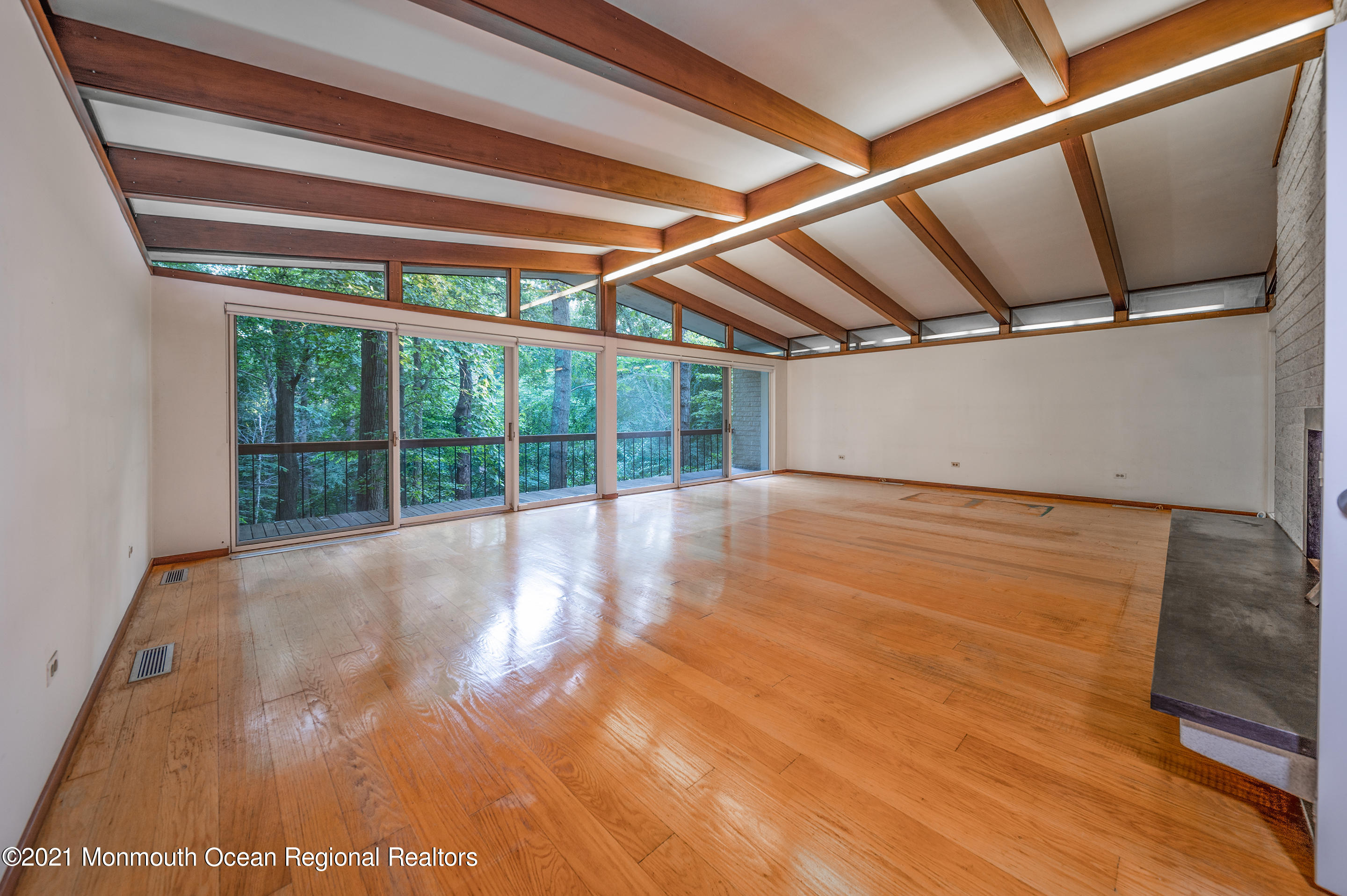 277 Mc Clees Road Red Bank, NJ 07701 - Photo 11 of 53 a view of an empty room with wooden floor and windows