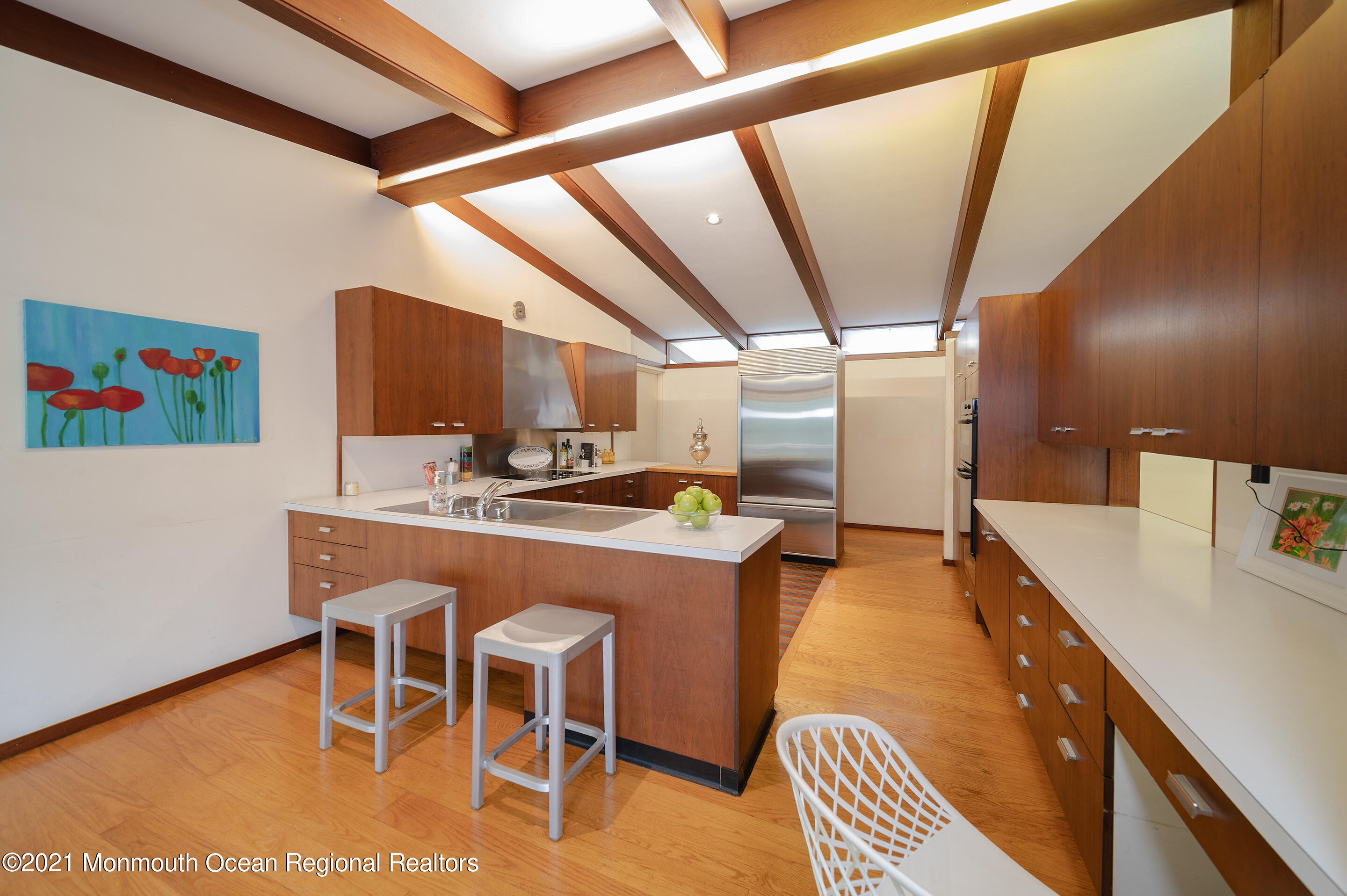 277 Mc Clees Road Red Bank, NJ 07701 - Photo 17 of 53 a dining hall with stainless steel appliances granite countertop a sink a stove a dining table and chairs with wooden floor
