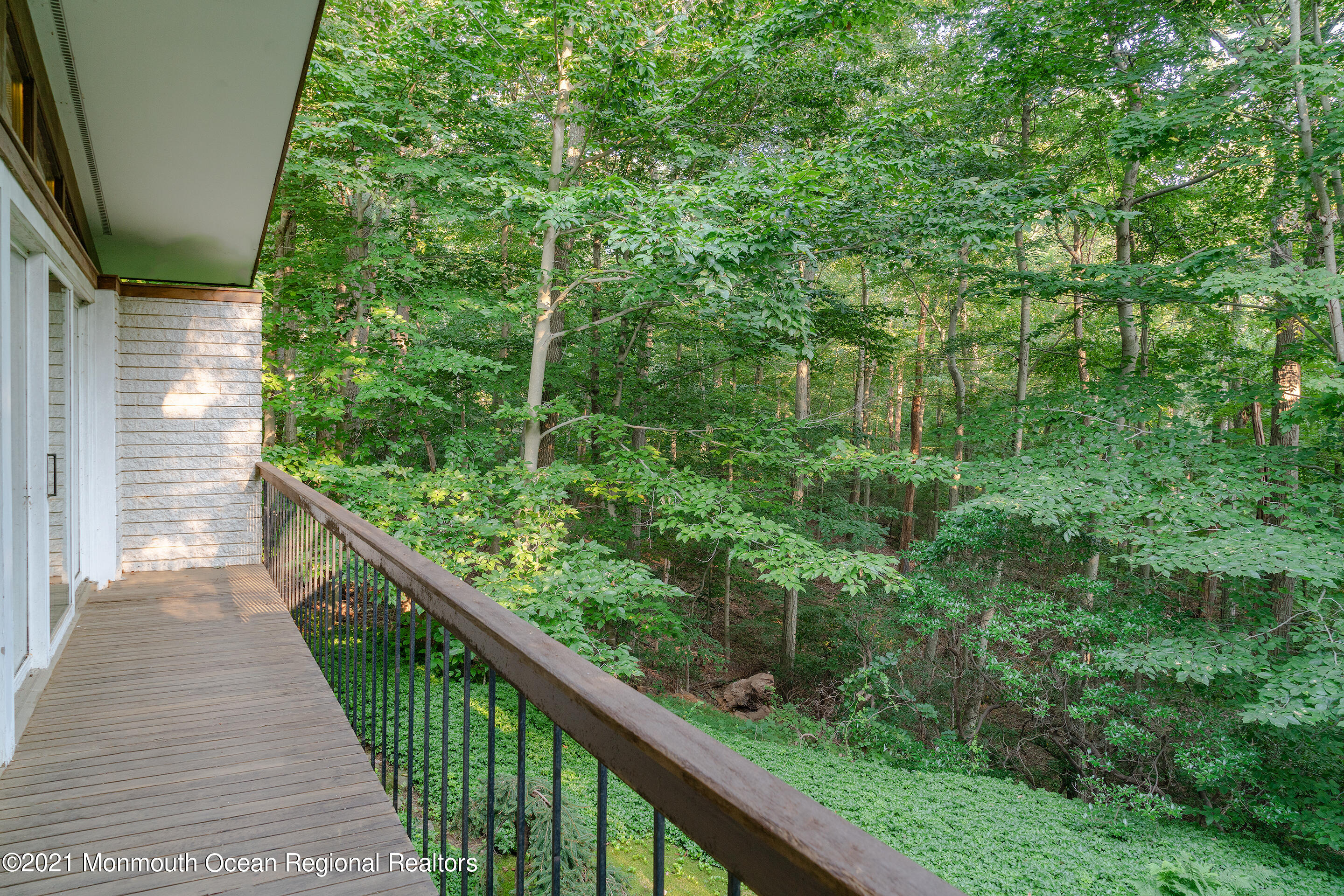 277 Mc Clees Road Red Bank, NJ 07701 - Photo 29 of 53 a balcony with trees in front of it