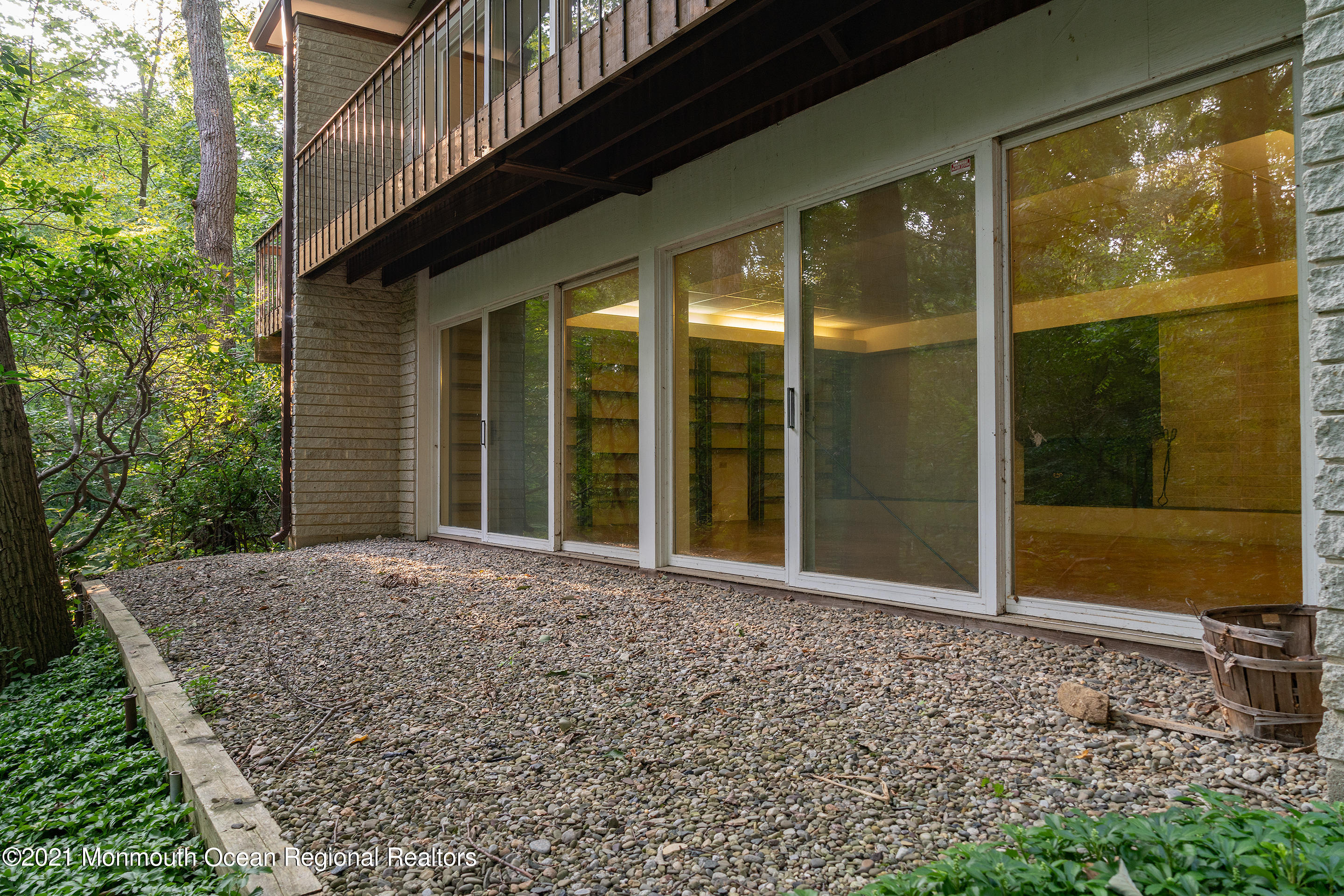 277 Mc Clees Road Red Bank, NJ 07701 - Photo 41 of 53 a view of a porch with a floor to ceiling window and garden