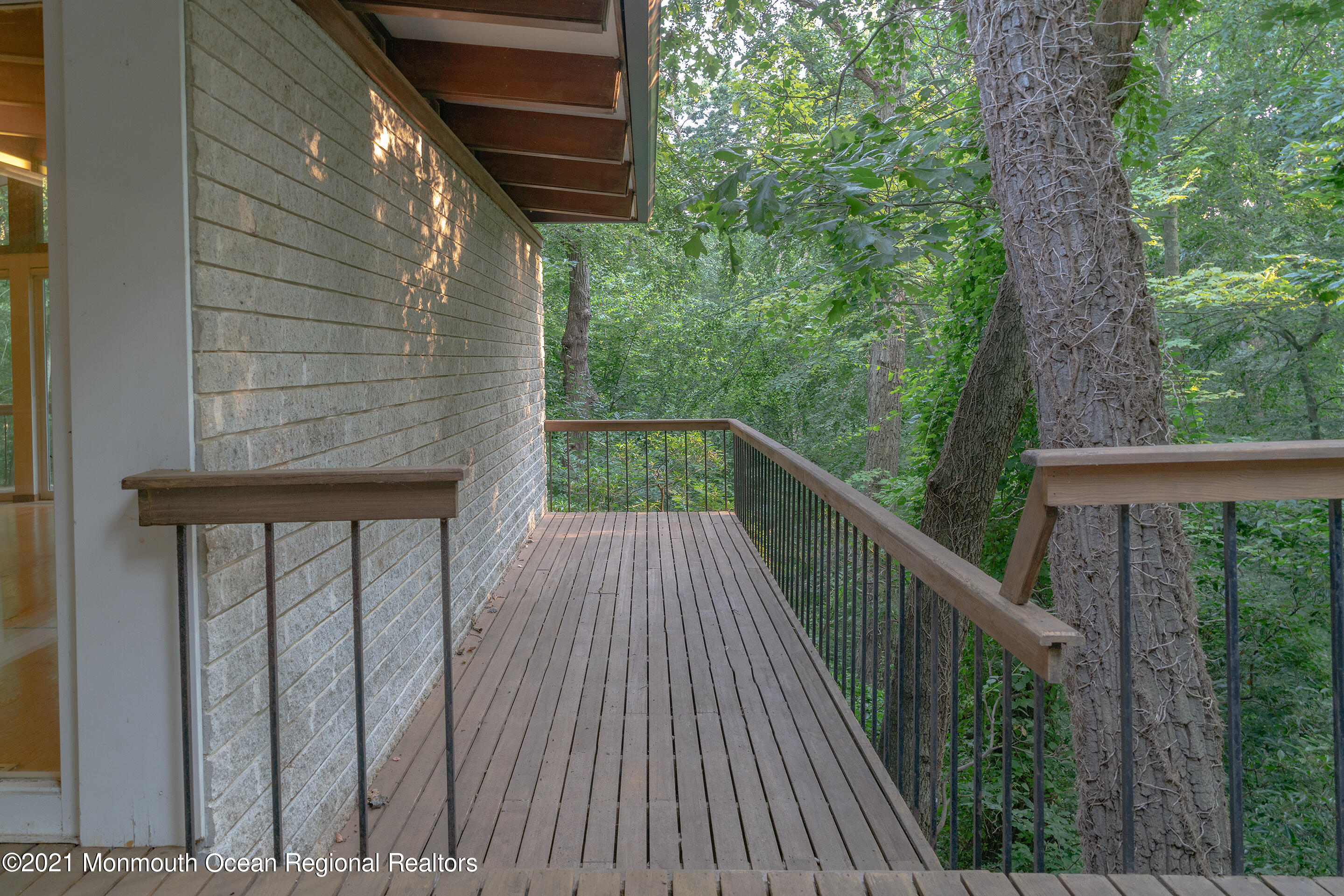 277 Mc Clees Road Red Bank, NJ 07701 - Photo 42 of 53 a balcony with trees in front of it