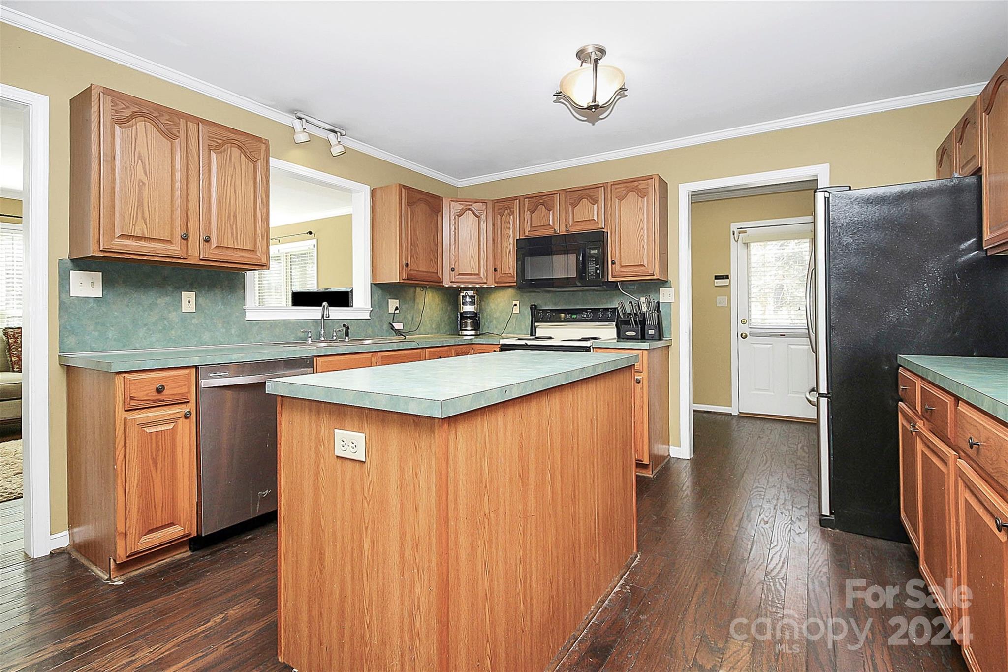 125 Vinson Road Rock Hill, SC 29730 - Photo 8 of 39 a kitchen with stainless steel appliances granite countertop a stove a sink dishwasher a refrigerator and a microwave oven with wooden floor