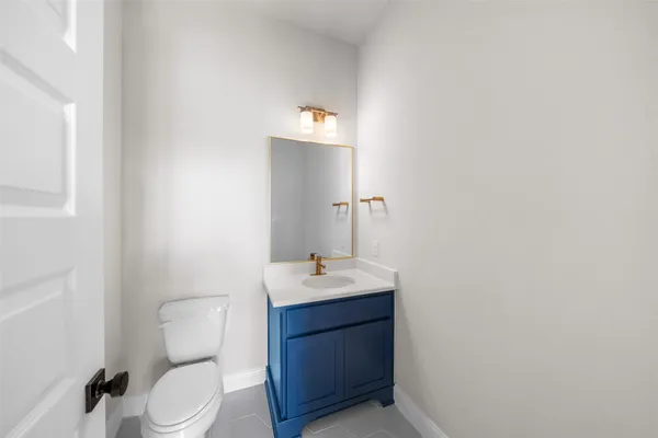 a bathroom with a sink vanity mirror and toilet