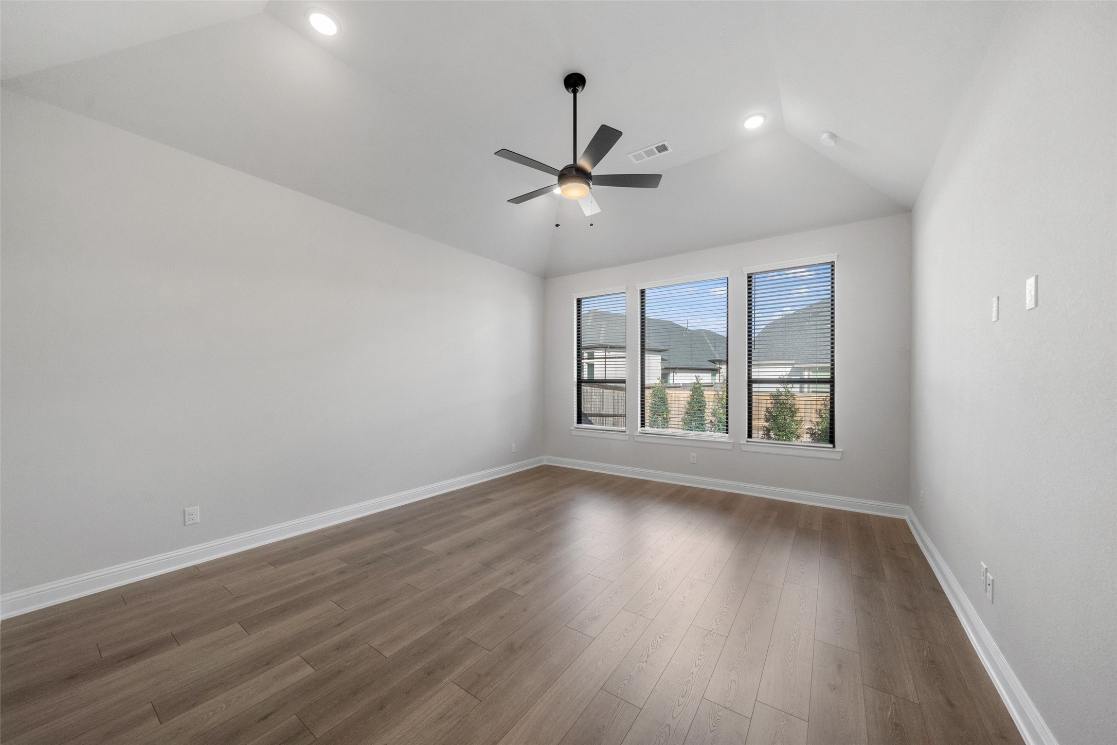 15464 Ringbill Way Magnolia, TX 77354 - Photo 22 of 37 an empty room with wooden floor ceiling fan and windows