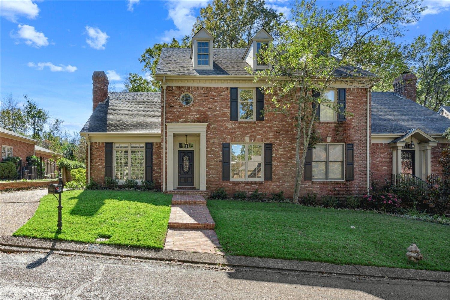 7215 Plantation Circle Germantown, TN 38138 - Photo 1 of 30 a front view of a house with a garden and plants