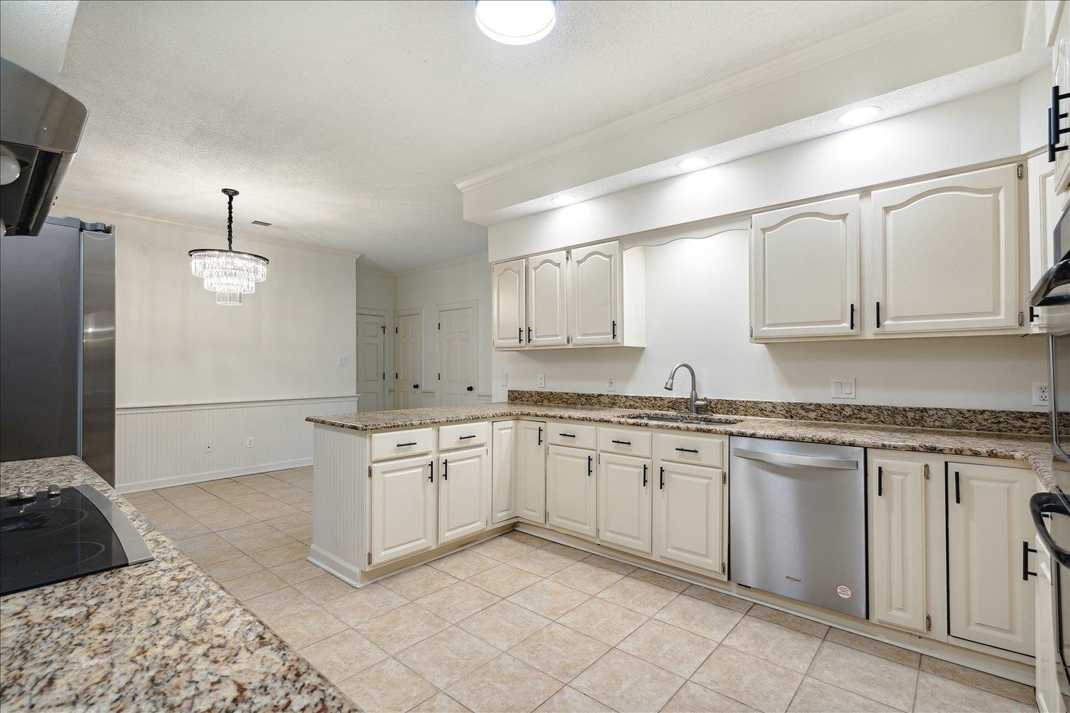 7215 Plantation Circle Germantown, TN 38138 - Photo 14 of 30 a large kitchen with granite countertop a sink and dishwasher a stove with wooden floor