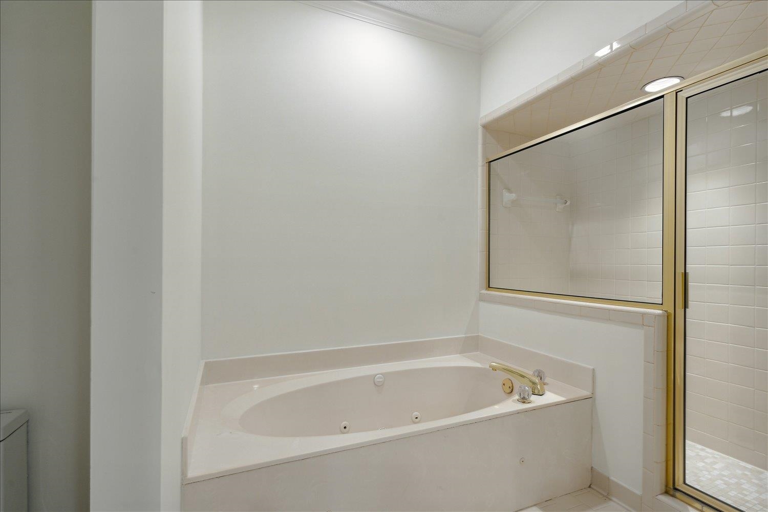 7215 Plantation Circle Germantown, TN 38138 - Photo 20 of 30 a white bath tub sitting next to a white sink and vanity