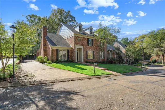 a house that has a tree in front of it