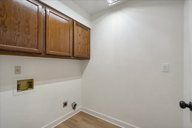 a view of storage and utility room with wooden floor